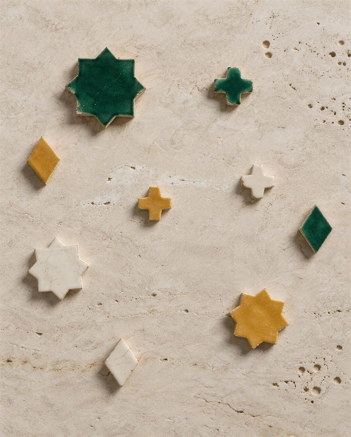 Zellige fragments on travertine